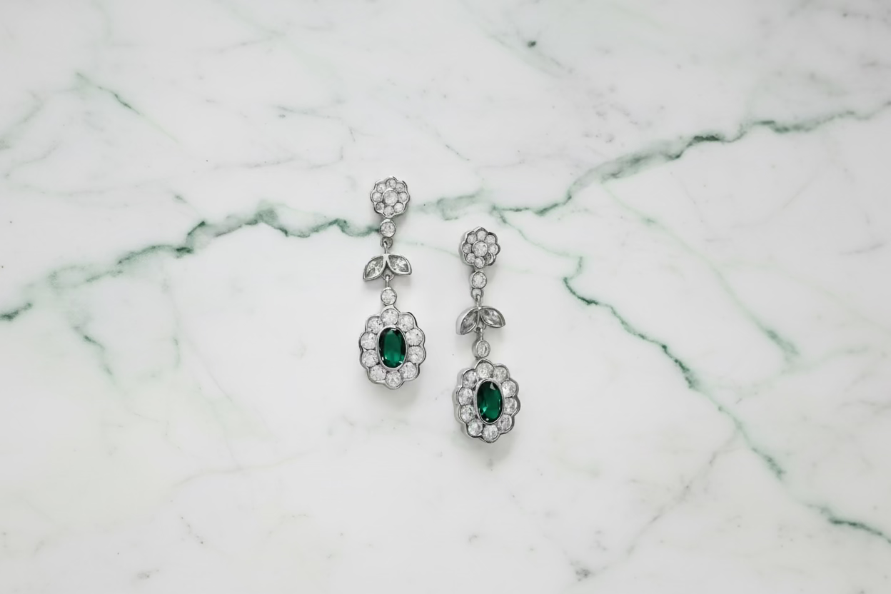 Silver earrings with green circuses.