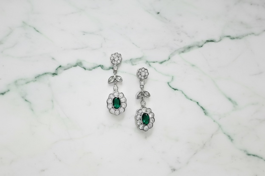 Silver earrings with green circuses.